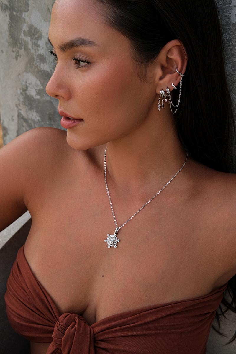 A beautiful model wearing Silver layered ear cuff set with chains and a silver chain with pendant.