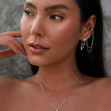 Model wearing Silver layered ear cuff set with chains and a silver chain with pendant.