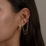 Iris Siren Petra-Gold chain earrings with layered draped design on ear.