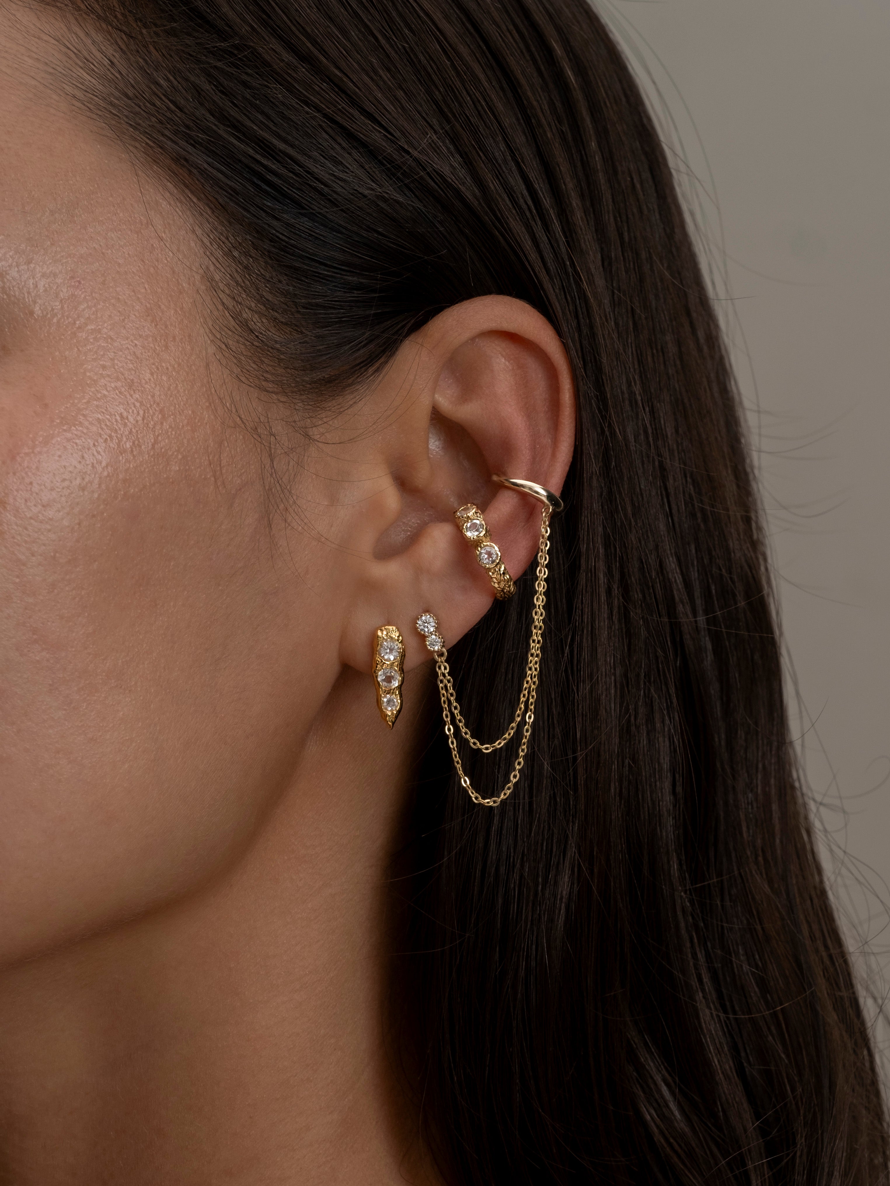 Iris Siren Petra-Gold chain earrings with layered draped design on ear.