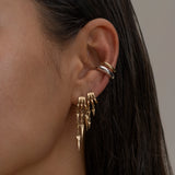 Paloma Gold ear cuffs and dangling earrings on wet dark hair.