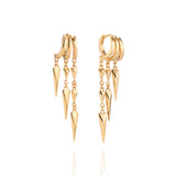 A pair of gold illusion earrings with dangling geometric spike charms, displayed on a white background.