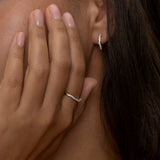 Elegant gold Riviera ring on hand with matching earring