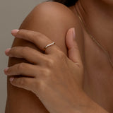 Elegant gold ring on hand with matching necklace