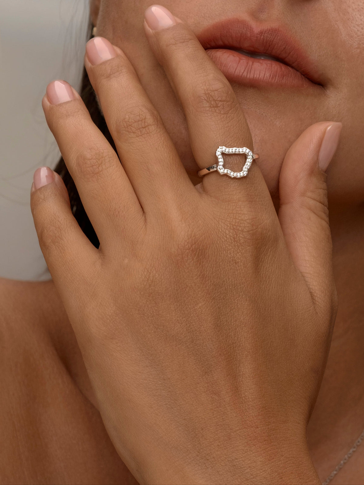 Women wear Silver ring with an open, irregular diamond-shaped design.