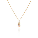 Sahara Mini gold necklace with a round gemstone pendant.