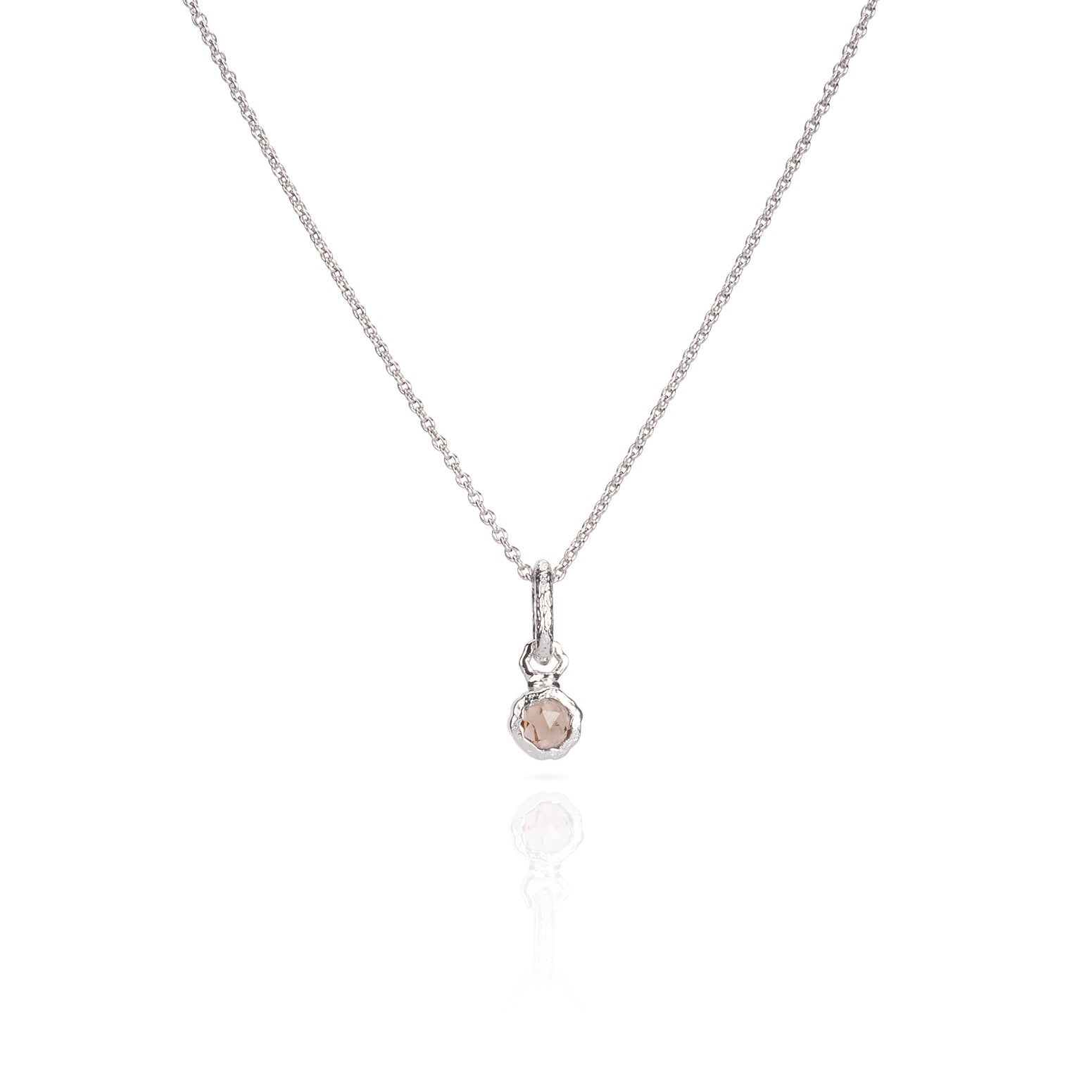 A silver necklace with a round gemstone pendant.