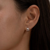 Minimalist silver triple-hoop earrings on ear