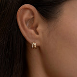 Minimalist gold triple-hoop earrings on ear
