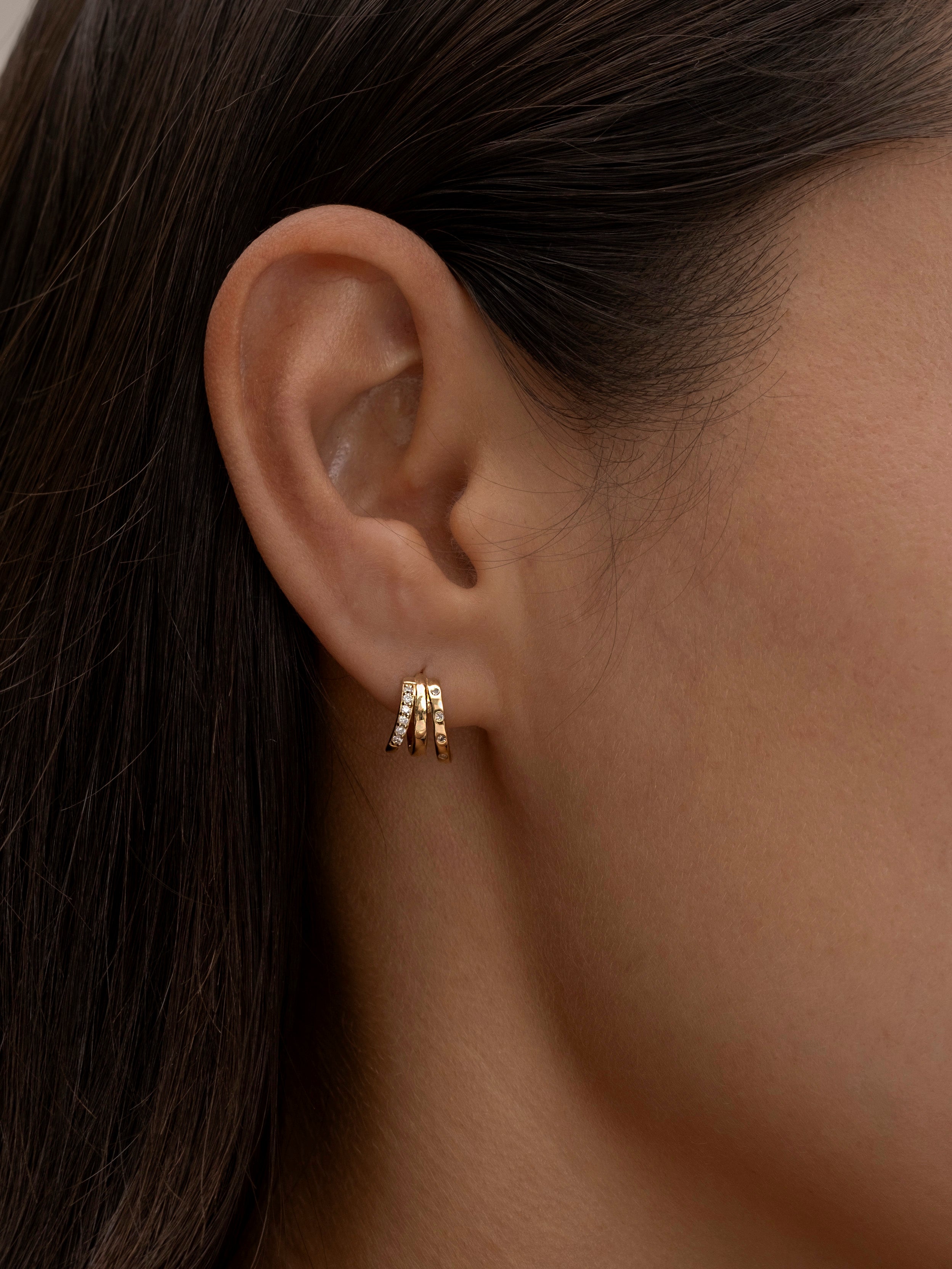 Minimalist gold triple-hoop earrings on ear