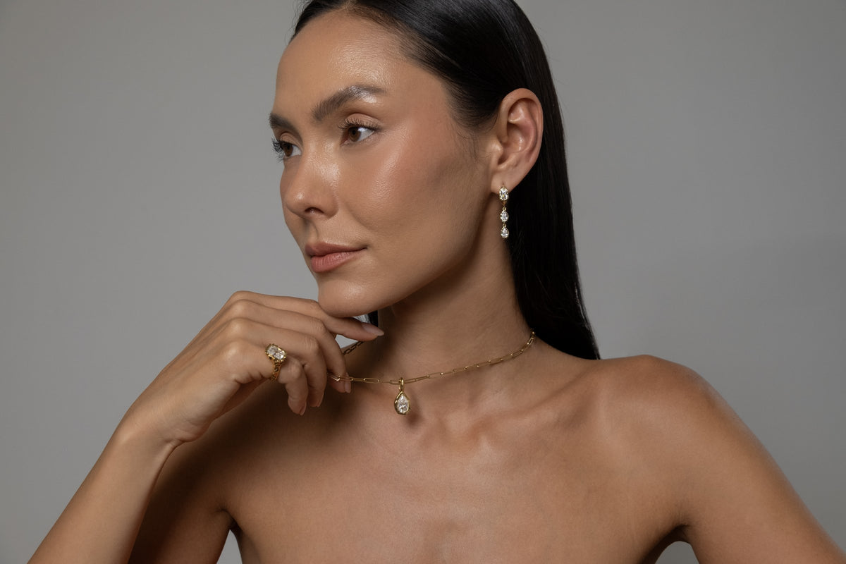 Model wearing Brooklyn Earrings (moissanite), Molten Pear Pendant (moissanite), Paperlink Chain