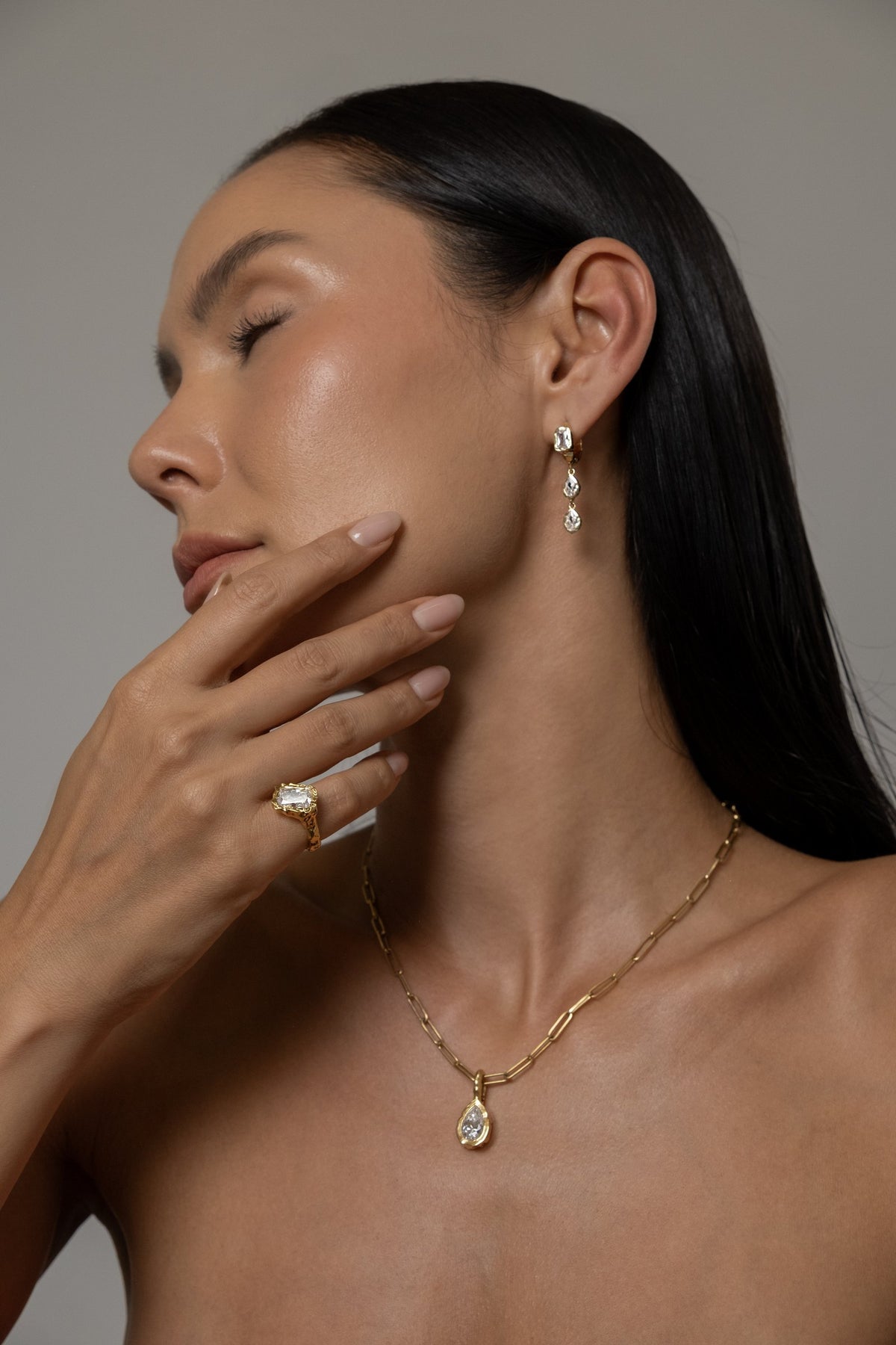 Model wearing Brooklyn Earrings (moissanite), Molten Pear Pendant (moissanite), Paperlink Chain, Molten Square Ring (moissanite)
