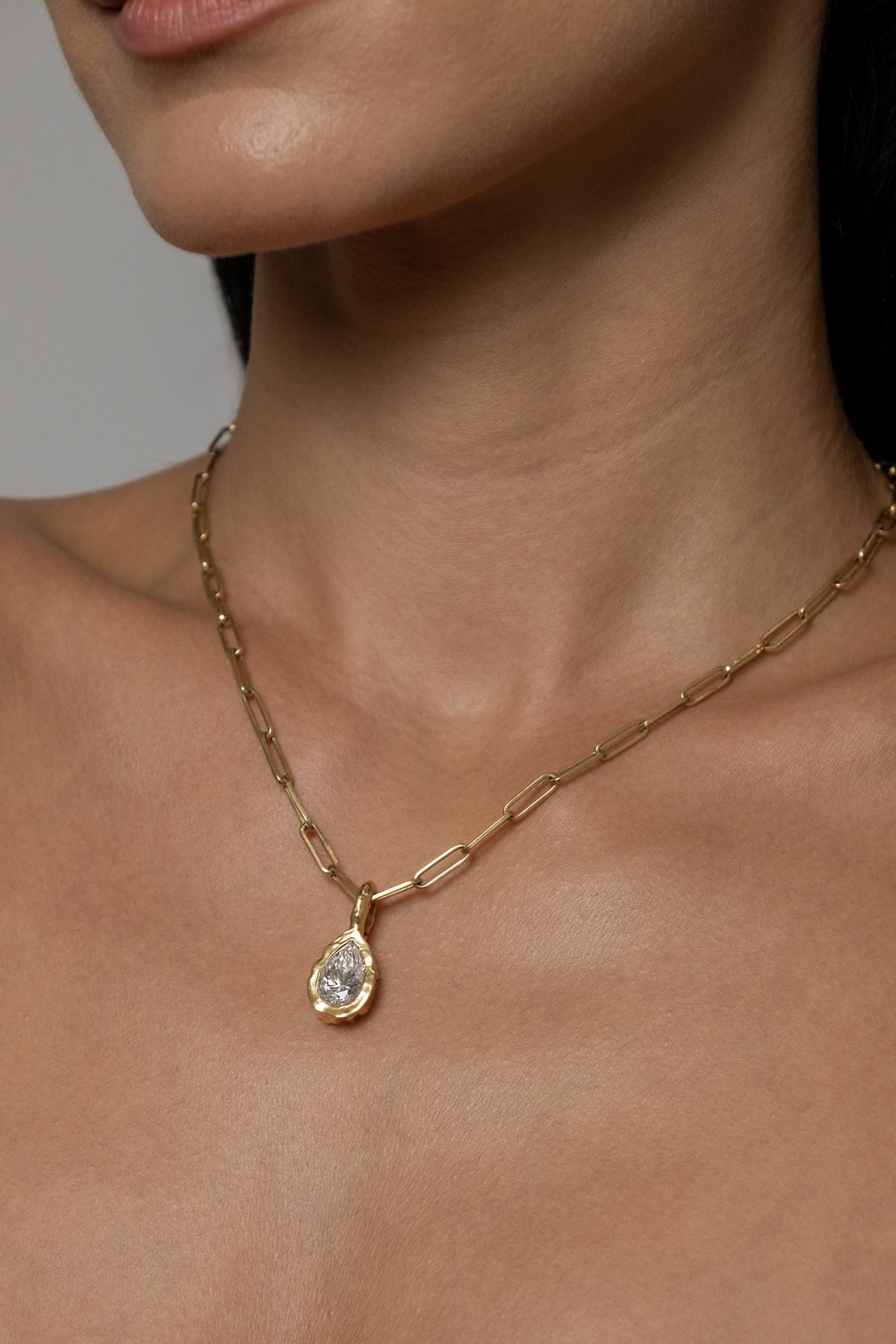 Model wearing Molten Pear Pendant (moissanite), Paperlink Chain