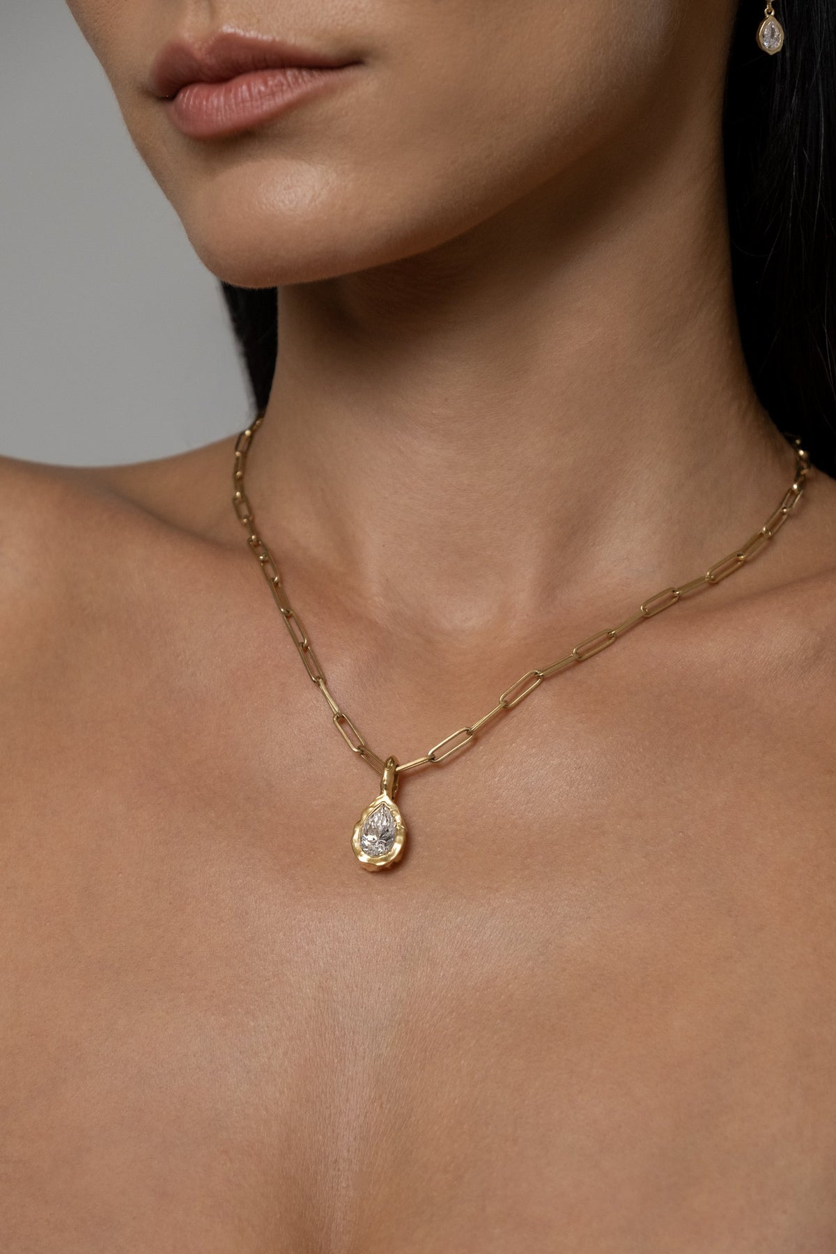 Model wearing Molten Pear Pendant (moissanite), Paperlink Chain