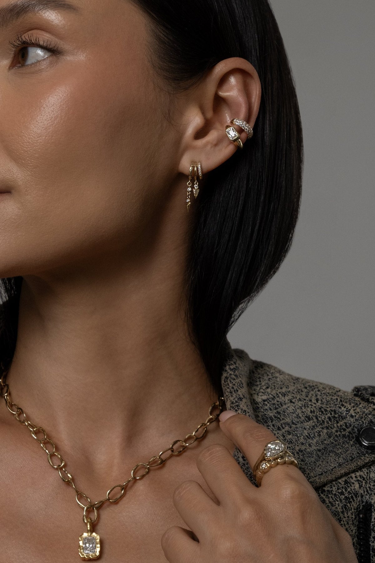 Model wearing Molten Square Pendant (moissanite), Mini Monaco Necklace, Molten Pear Ring (moissanite), Pixie Cuff (moissanite)