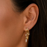 Gold hoop earrings with cross charm and crystal details