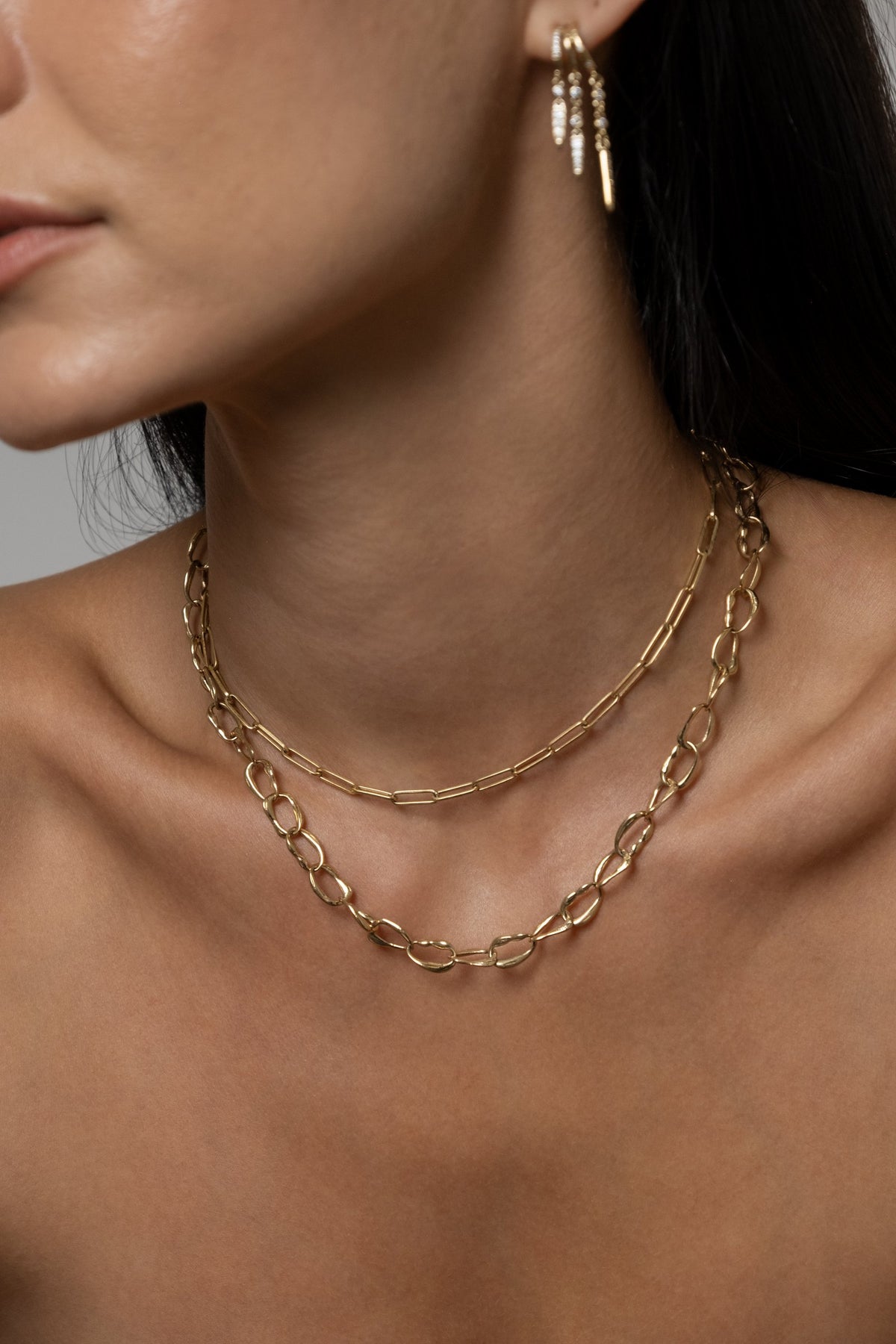 Model wearing Rio Earrings, Paperlink Chain, Mini Monaco Necklace