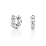 Pair of silver huggie earrings with pavé diamonds.