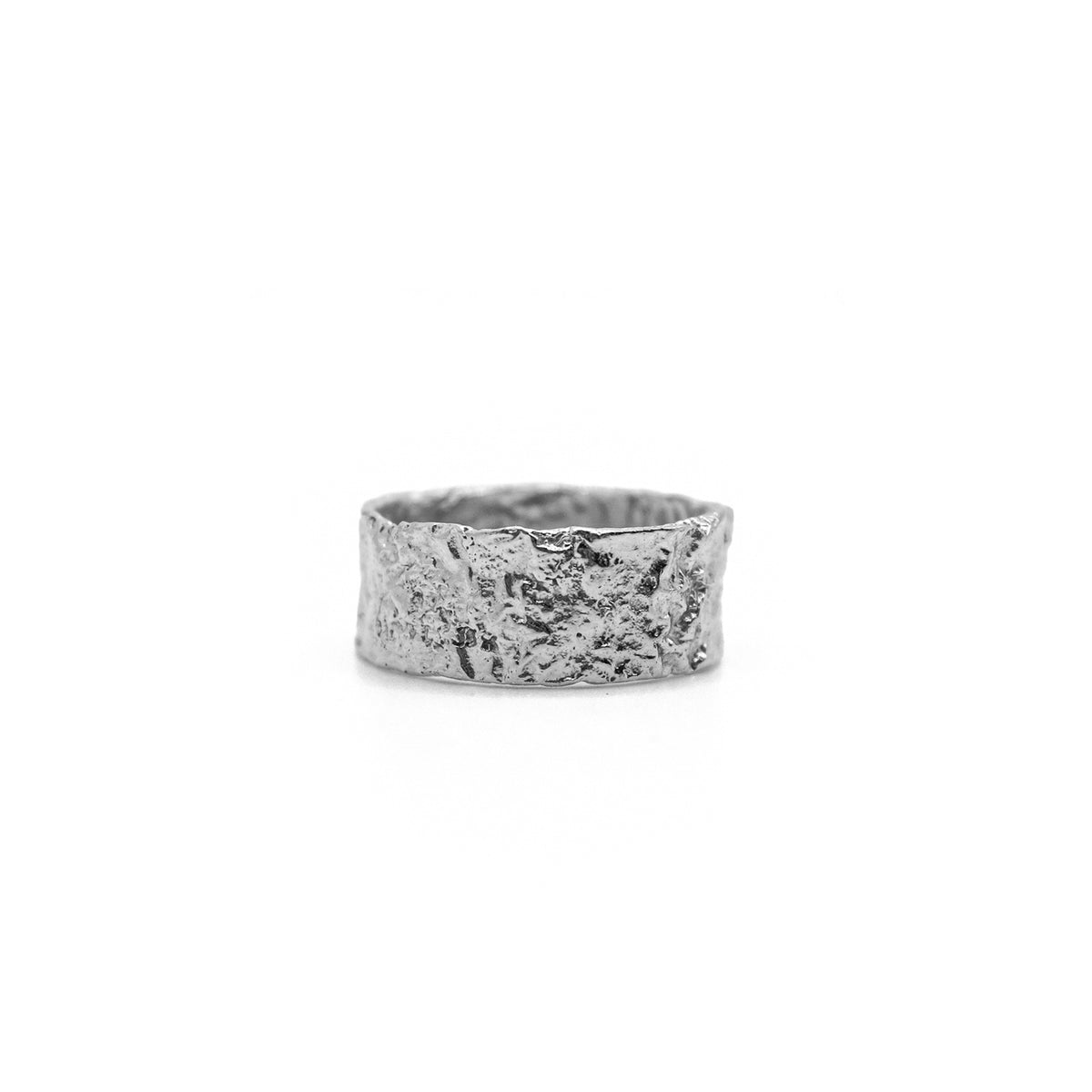 Silver textured wide band ring with a rough, organic finish.
