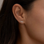 Silver Chloe stud earring on a woman's ear.