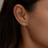 Silver Chloe stud earring on a woman's ear.