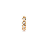 Close up of gold Milano hoop earring with bezel-set gemstones.