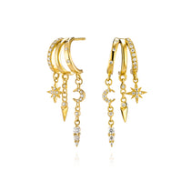Gold hoop earrings with stars, moons, and crystal drops.