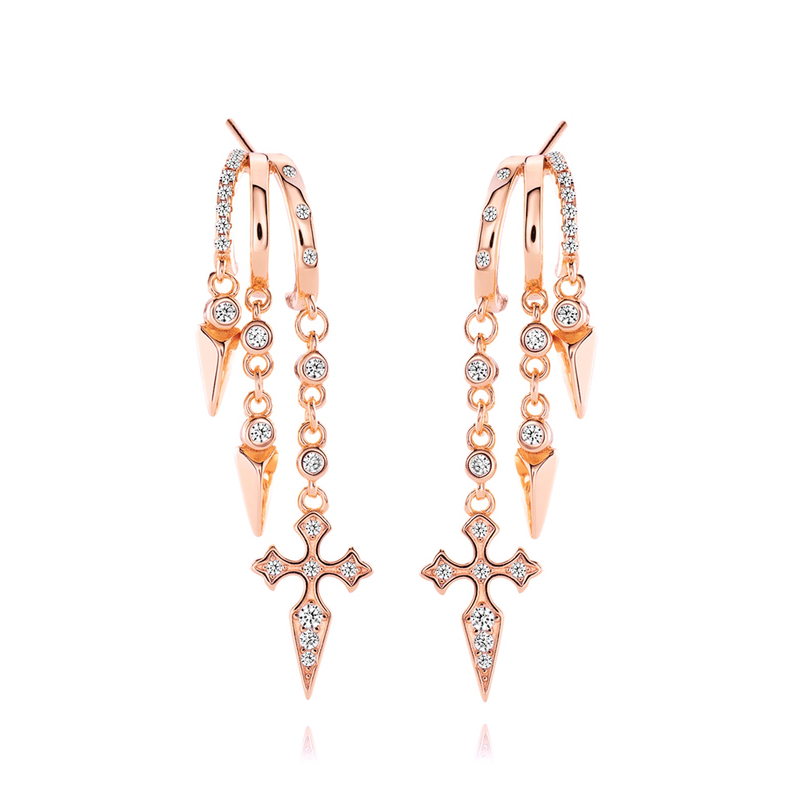 Rose gold dangling earrings with cross and spike details.