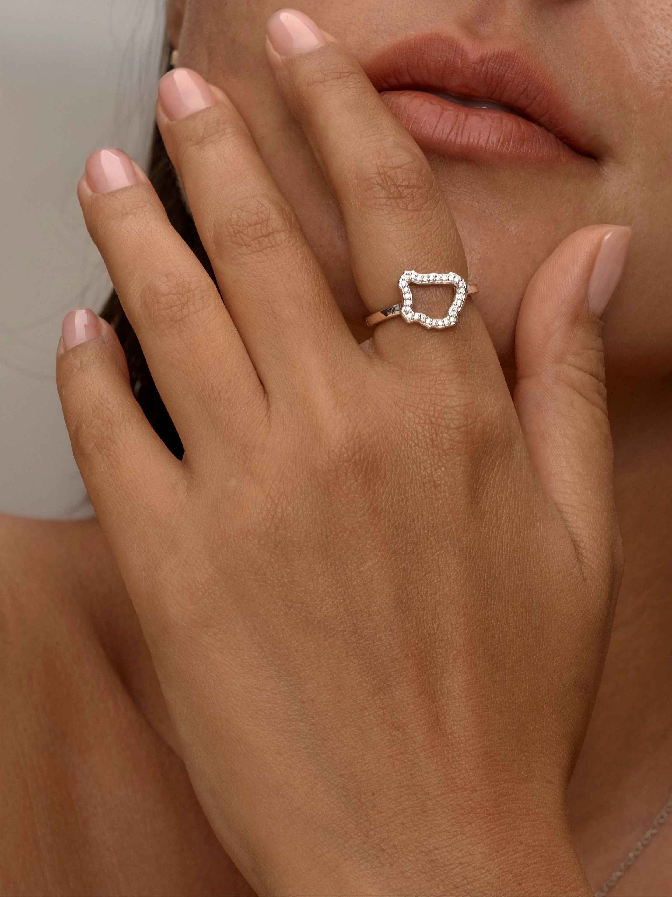 Women wear Silver ring with an open, irregular diamond-shaped design.