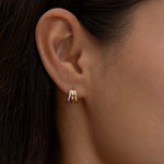 Minimalist gold triple-hoop earrings on ear