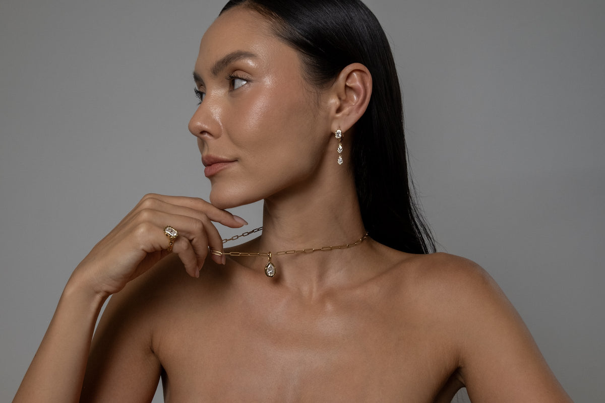 Model wearing Brooklyn Earrings (moissanite), Molten Pear Pendant (moissanite), Paperlink Chain
