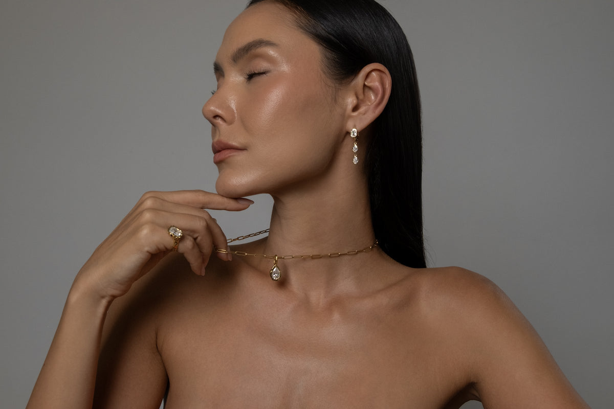 Model wearing Brooklyn Earrings (moissanite), Molten Pear Pendant (moissanite), Paperlink Chain