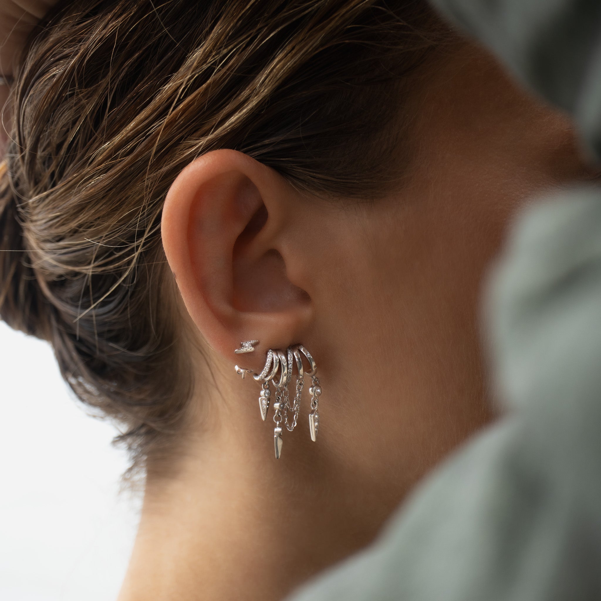 Silver hoop earrings with chains and spike charm details